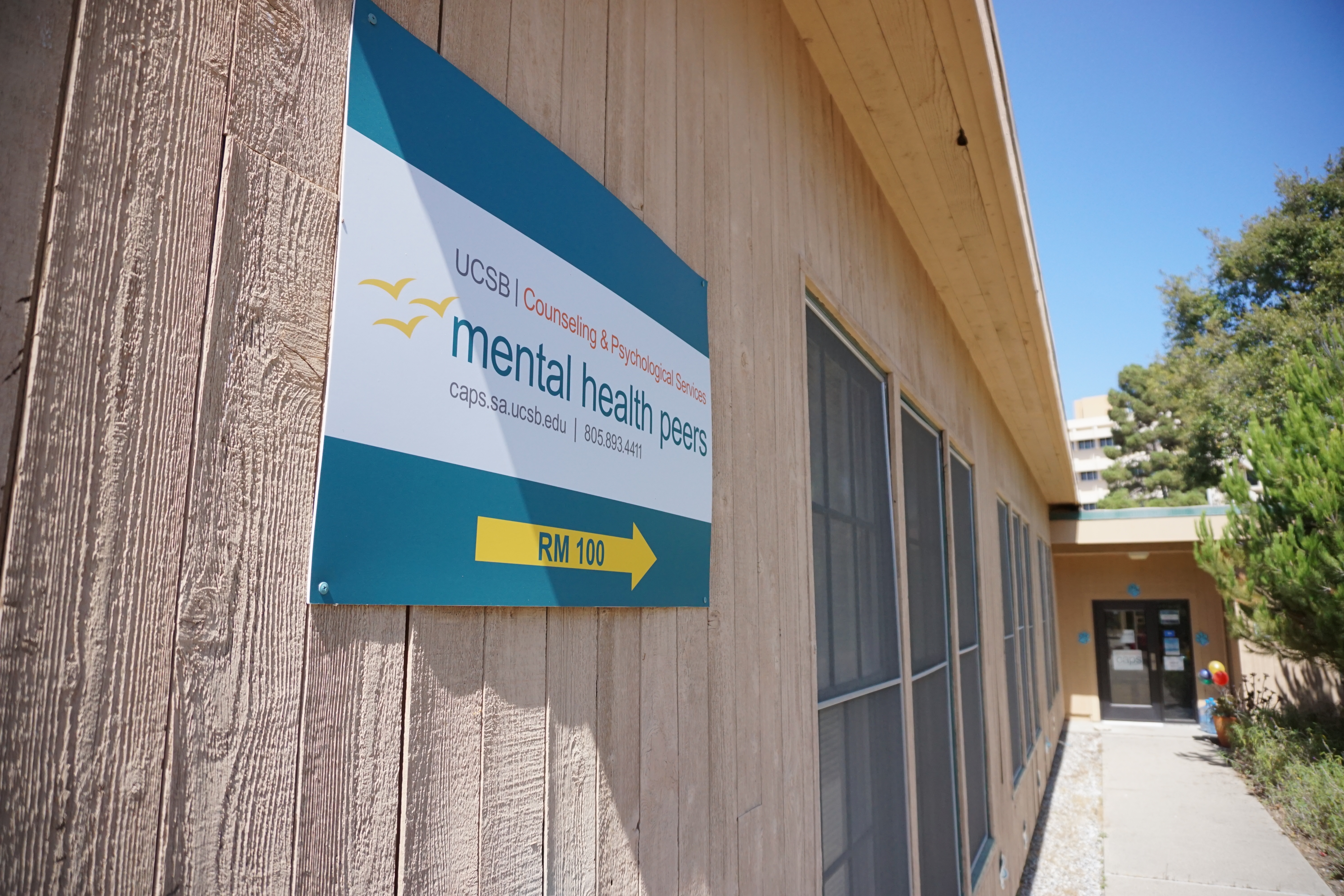 Mental Health Peers Sign pointing towards MHP Office door.